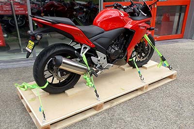 Motorbike securely strapped to base of packing crate